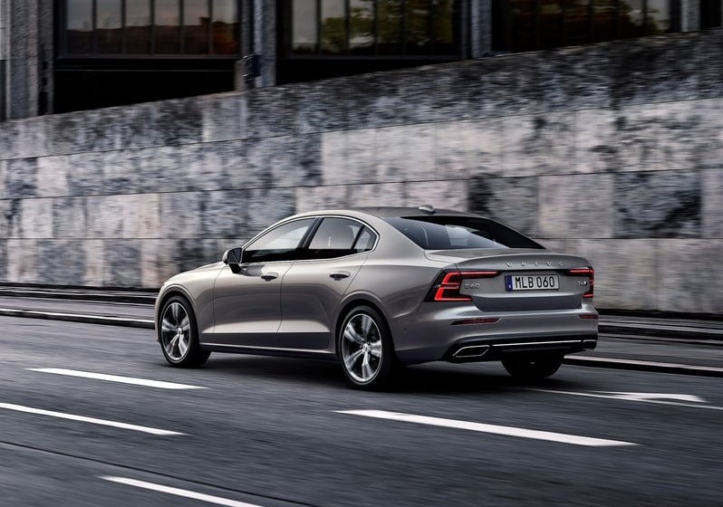 Gri Volvo S60 hareket halinde arka üç çeyrek görünümü