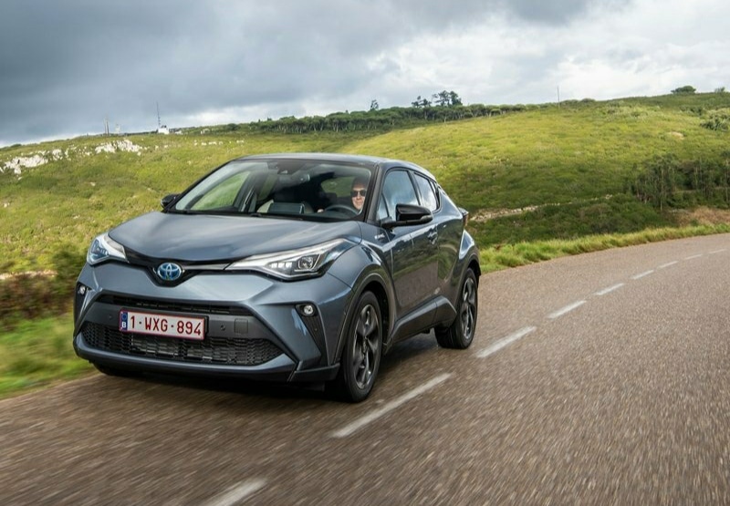 Gri Toyota C-HR yolda hareket halinde önden görünüm