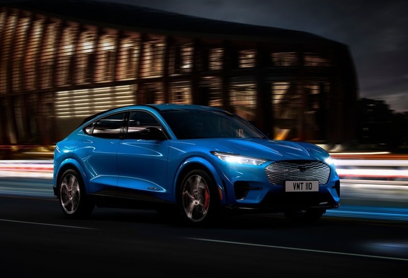 Ford Mustang Mach E mavi gövdeyle gece yolunda önden üç çeyrek görünüm