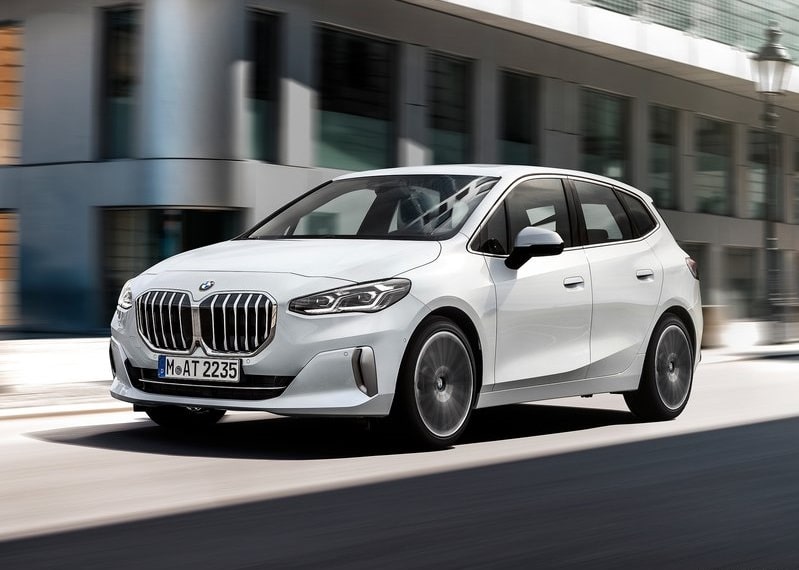 Beyaz BMW Active Tourer şehir içinde önden hareket halinde